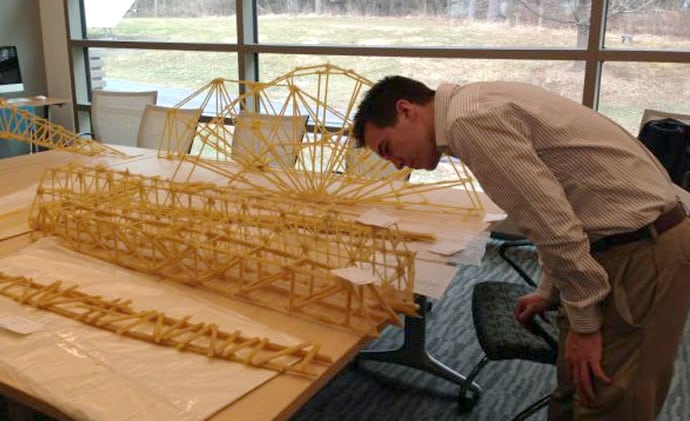 man inspects an engineering model