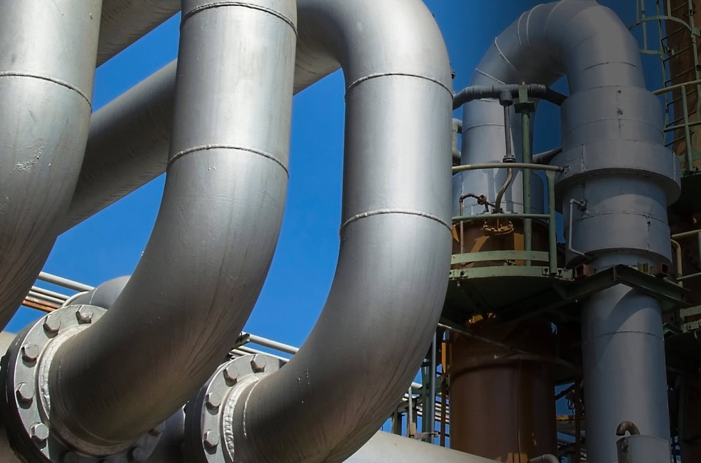 a close-up of large industrial pipes with prominent curves and joints