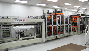 A bay for thermoforming long trays for medical devices and catheters.
